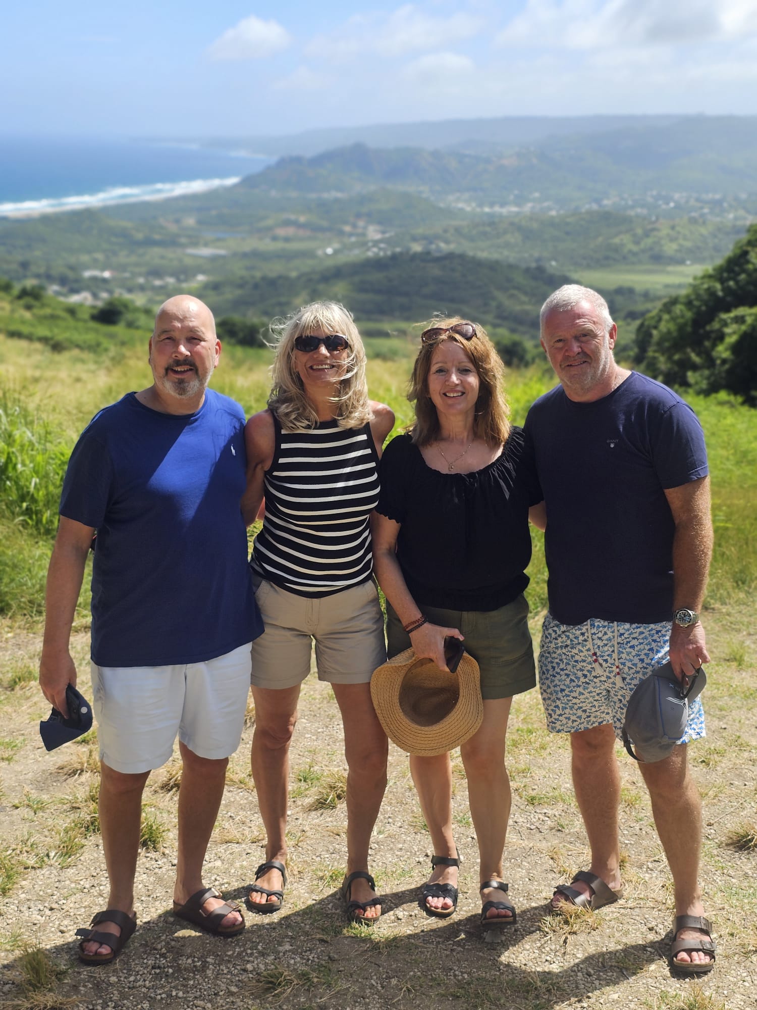 Two couples at a Barbados island viewpoint overlooking the coast