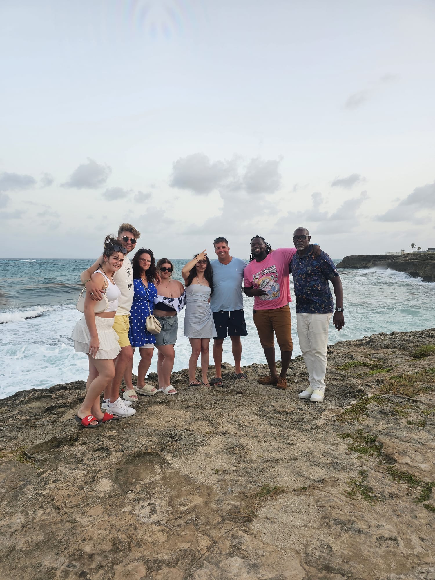 Tour group on a rocky Barbados coastline during a private island tour