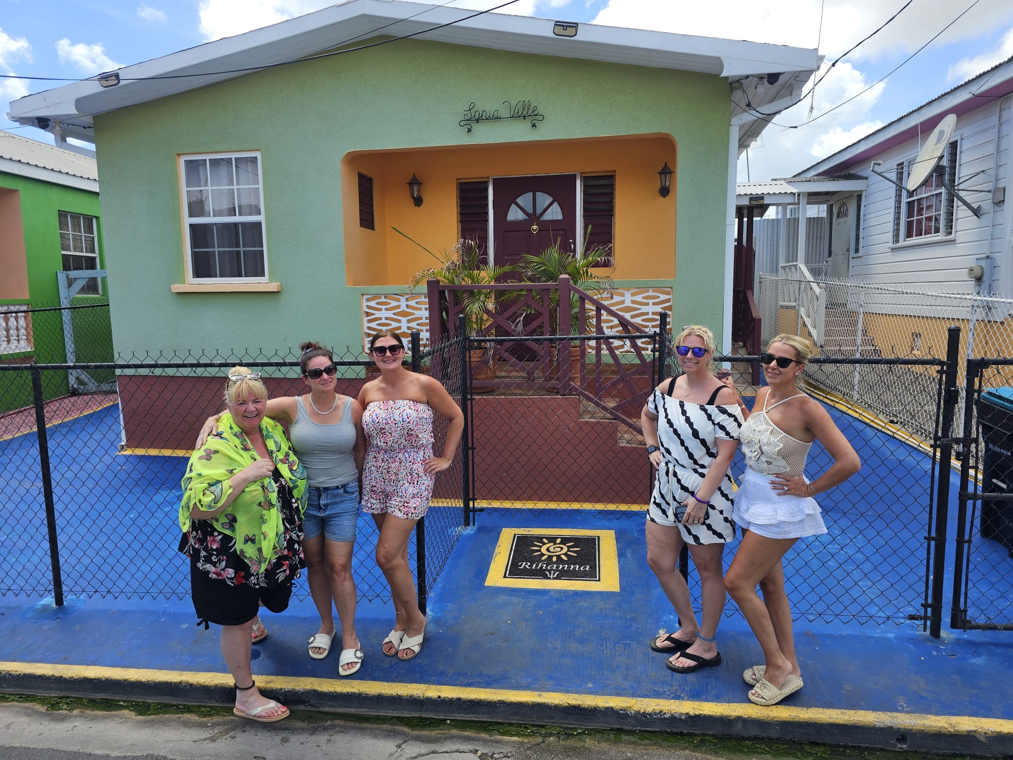 Guests outside a colourful Barbadian chattel house on a private tour